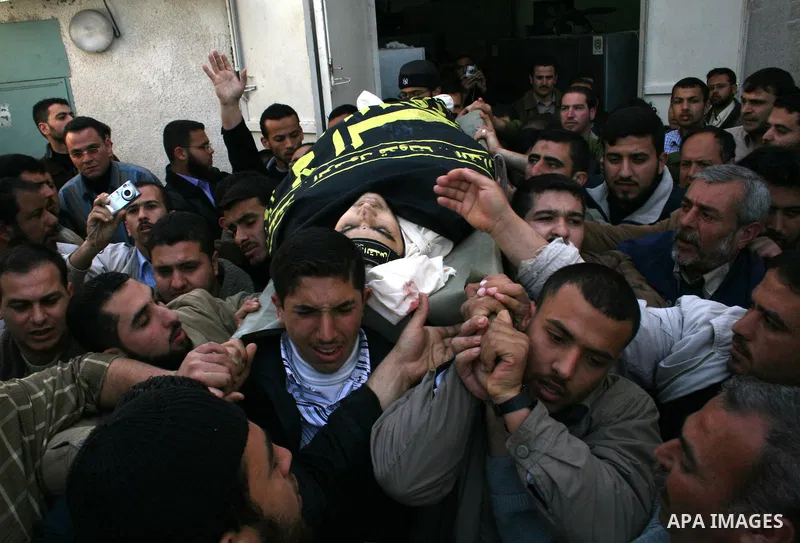 Palestinian mourners carry the body of Hassan Shaqora, one of the three Islamic Jihad militants killed in Israeli airstrikes, during his funeral in Beit Lahia, northern Gaza Strip. An Israeli air strike today killed thre...