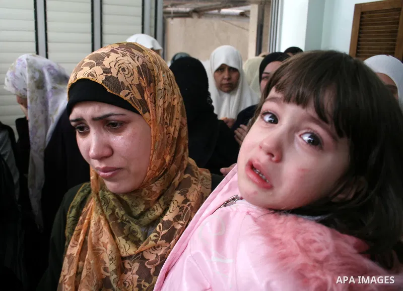 Palestinian relatives mourn during the funeral of Hassan Shaqora, one of the three Islamic Jihad militants killed in Israeli airstrikes, in Beit Lahia, northern Gaza Strip. An Israeli air strike today killed three Islami...