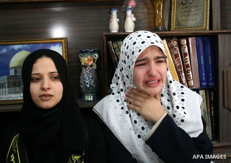 Palestinian relatives mourn during the funeral of Hassan Shaqora, one of the three Islamic Jihad militants killed in Israeli airstrikes, in Beit Lahia, northern Gaza Strip. An Israeli air strike today killed three Islami...