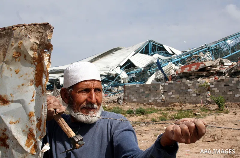 A Palestinian man walks on the rubble of his factory which was destroyed during the Gaza war in Jabalia in the northern Gaza Strip on April 30, 2009, a day before World Labour Day (May Day) APAIMAGES PHOTO / Ashraf Amra