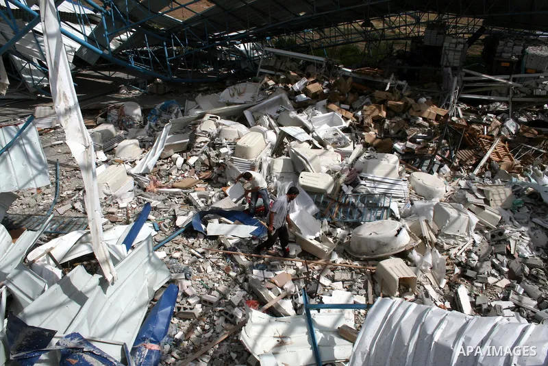 A Palestinian man walks on the rubble of his factory which was destroyed during the Gaza war in Jabalia in the northern Gaza Strip on April 30, 2009, a day before World Labour Day (May Day) APAIMAGES PHOTO / Ashraf Amra