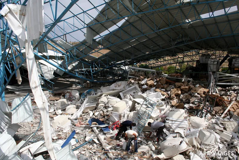 A Palestinian man walks on the rubble of his factory which was destroyed during the Gaza war in Jabalia in the northern Gaza Strip on April 30, 2009, a day before World Labour Day (May Day) APAIMAGES PHOTO / Ashraf Amra