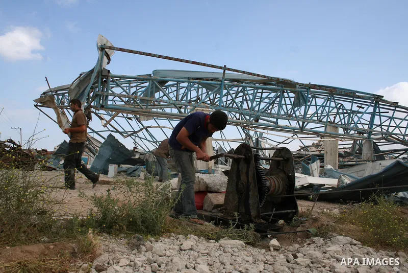A Palestinian man walks on the rubble of his factory which was destroyed during the Gaza war in Jabalia in the northern Gaza Strip on April 30, 2009, a day before World Labour Day (May Day) APAIMAGES PHOTO / Ashraf Amra
