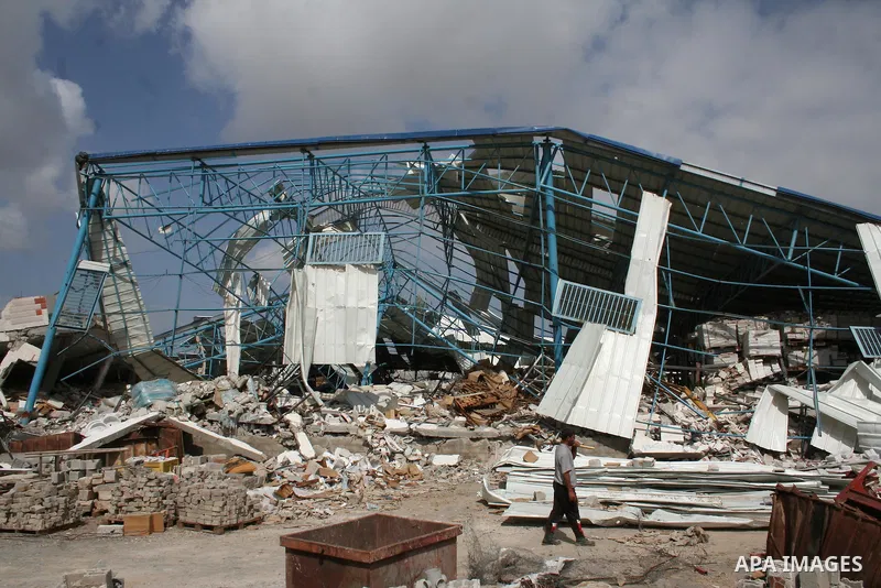A Palestinian worker walks past the rubble of Al-Haddad tile factory in Jabalia in the northern Gaza Strip on April 30, 2009, a day before World Labour Day (May Day). At least 10 workers lost their jobs when the factory...