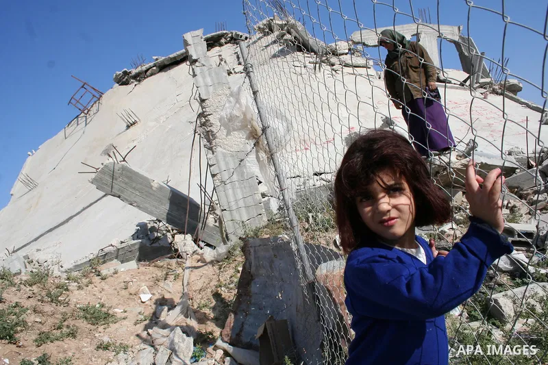 Palestinians walk on the rubble of destroyed buildings in the east of Jebaliya, northern Gaza Strip, on May 5, 2009 Israel blasted a harsh UN report on its three-week war on Gaza in January 2009 that is to be submitted t...