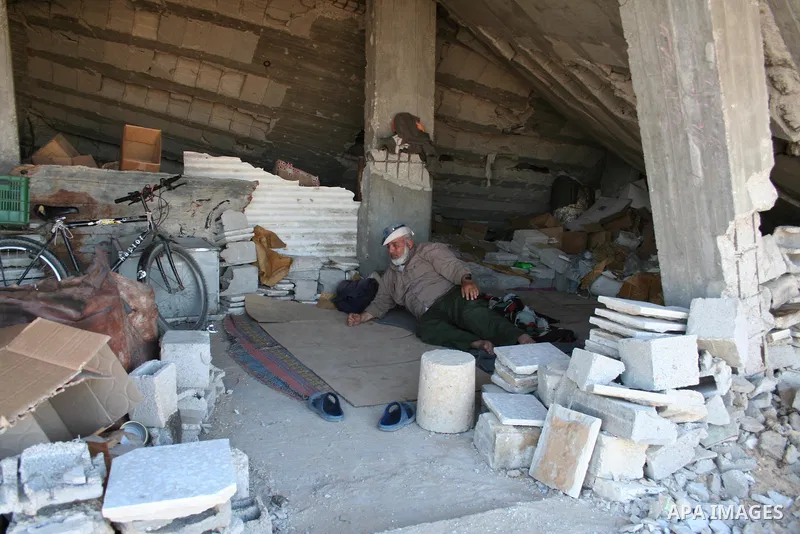 A Palestinian family sit next to their destroyed home in the area of east Jebaliya, in the northern Gaza Strip, Wednesday May 5, 2009. APAIMAGES PHOTO / Ashraf Amra