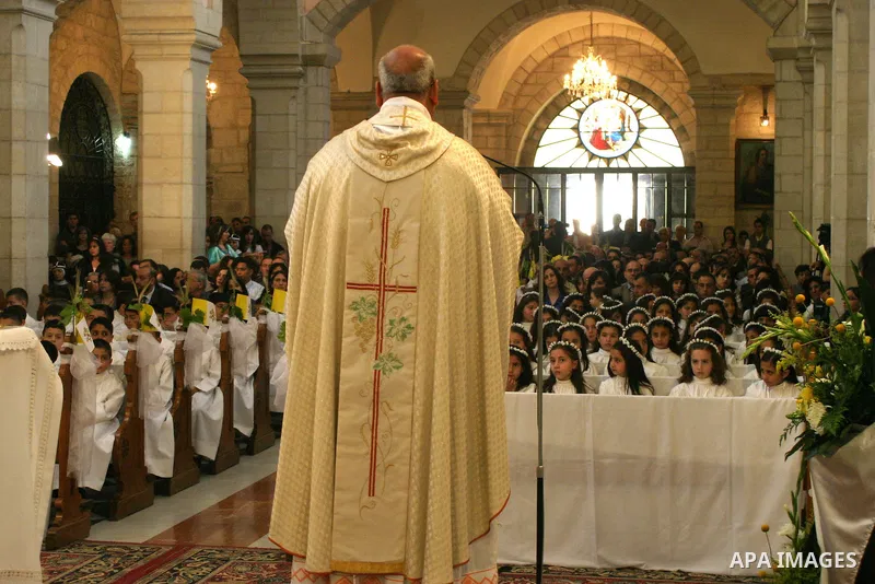 Palestinian Christians during Sunday Mass at the Church of the Nativity, traditionally believed to be the birthplace of Jesus Christ, in the West Bank city of Bethlehem, 10 May. 2009. Pope Benedict XVI on Sunday urged Mi...