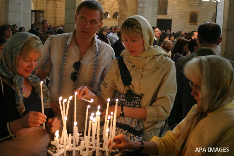 A Christian pilgrim lights a candle at the Church of the Nativity, traditionally believed by many to be the birthplace of Jesus Christ, in the West Bank town of Bethlehem,10 May 2009. Pope Benedict XVI on Sunday urged Mi...