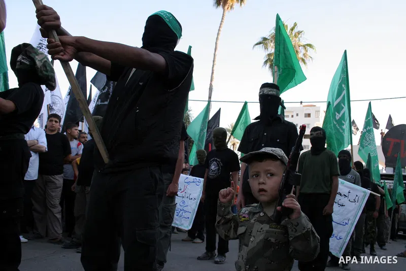 A masked member of Hamas's armed wing, the Ezzedine Al-Qassam Brigades, takes part in a demonstration in Gaza city on May 31, 2009 in protest against an attempt to arrest a senior Hamas commander in the West Bank town of...