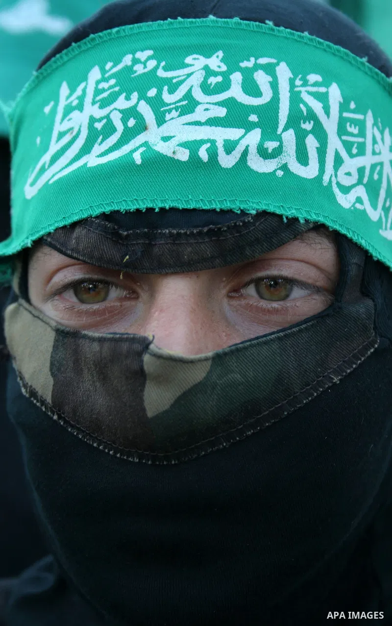 A masked member of Hamas's armed wing, the Ezzedine Al-Qassam Brigades, takes part in a demonstration in Gaza city on May 31, 2009 in protest against an attempt to arrest a senior Hamas commander in the West Bank town of...