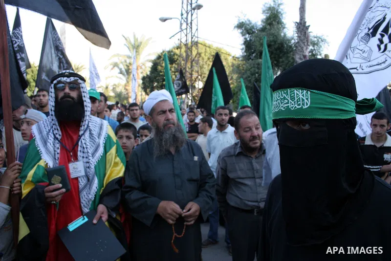 A masked member of Hamas's armed wing, the Ezzedine Al-Qassam Brigades, takes part in a demonstration in Gaza city on May 31, 2009 in protest against an attempt to arrest a senior Hamas commander in the West Bank town of...