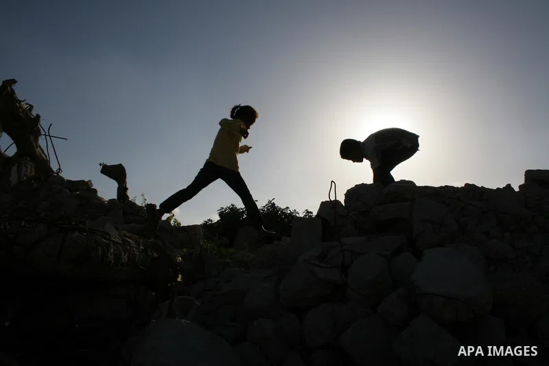 Palestinian children from al-Samoni family play atop the rubble of their house that was destroyed during Israel's offensive in the Gaza Strip earlier this year, in al-Zaitoun neighbourhood of Gaza City on June 2, 2009. T...