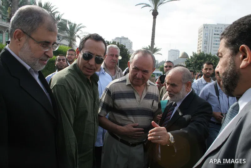 UN investigator Richard Goldstone walks with Hamas deputy Ahmed Bahr and members of his delegation as they visit the Palestinian parliament building that was destroyed during Israel's December-January offensive in Gaza C...