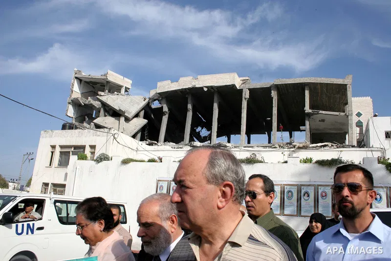 UN investigator Richard Goldstone walks with Hamas deputy Ahmed Bahr and members of his delegation as they visit the Palestinian parliament building that was destroyed during Israel's December-January offensive in Gaza C...