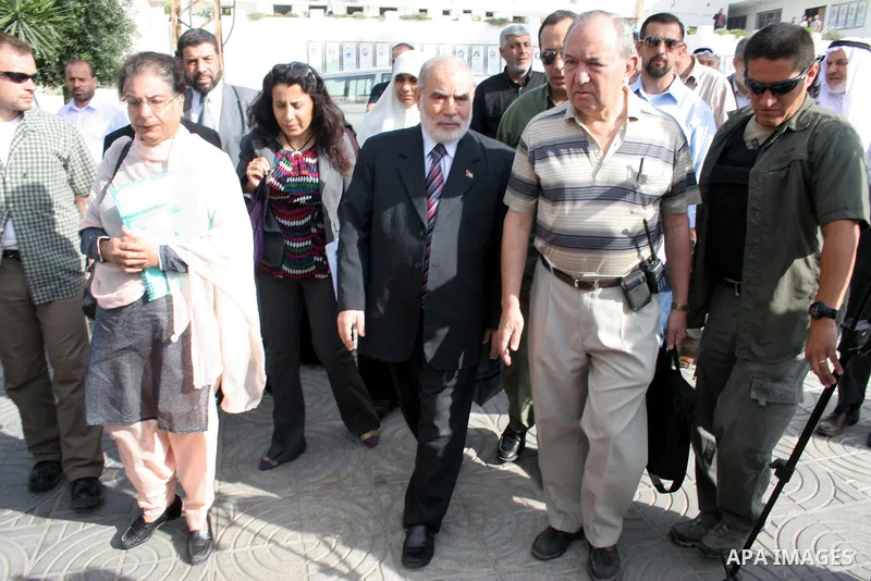 UN investigator Richard Goldstone walks with Hamas deputy Ahmed Bahr and members of his delegation as they visit the Palestinian parliament building that was destroyed during Israel's December-January offensive in Gaza C...