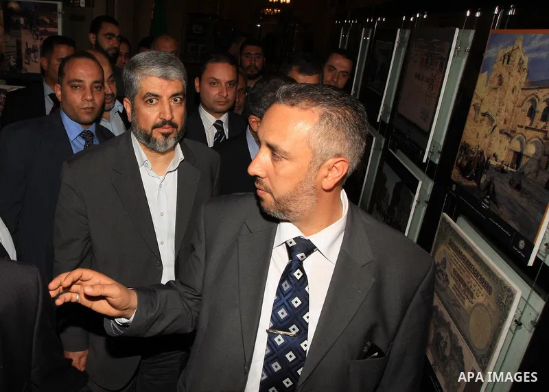 Palestinian Hamas leader Khaled Meshaal is escorted by security guards as he arrives to meet Arab League Secretary General Amr Mussa at the institution's headquarters in Cairo on June 9, 2009. Meshaal is on an official v...