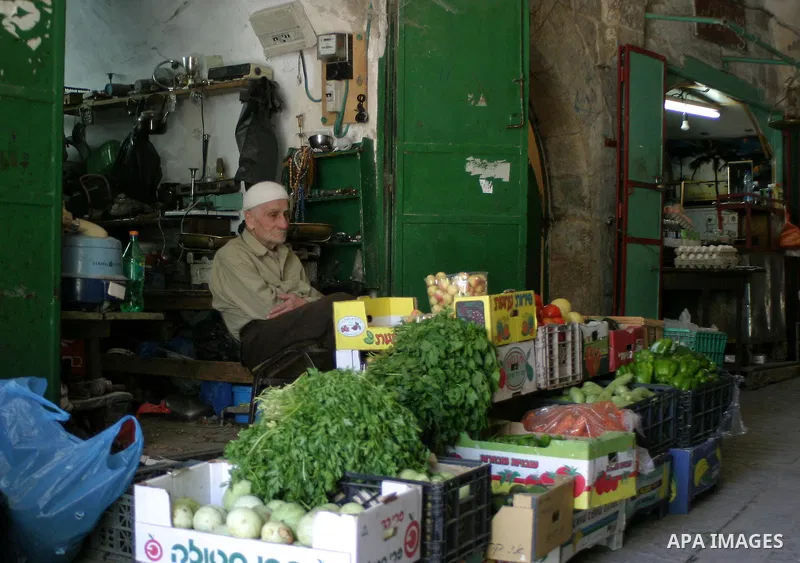 Palestinians shop in a traditional market at the ancient City in the West Bank city of Hebron on June 13, 2009. Photo\Najeh Hashlamoun