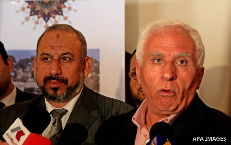 Azzam al-Ahmad (R), who heads Fatah's parliamentary bloc and Hamas movement's ex-finance minister Omar Abdul Razeq (L) hold a joint press conference following their talks in the West Bank city of Ramallah on June 14, 200...