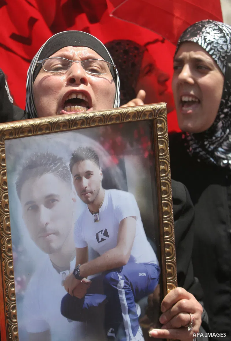 Palestinian hold Pictures of their relatives held in Israeli jails during a protest calling for their release, in the west bank city of Nablus on June 16, 2009. Photo\Nedal Shtieh