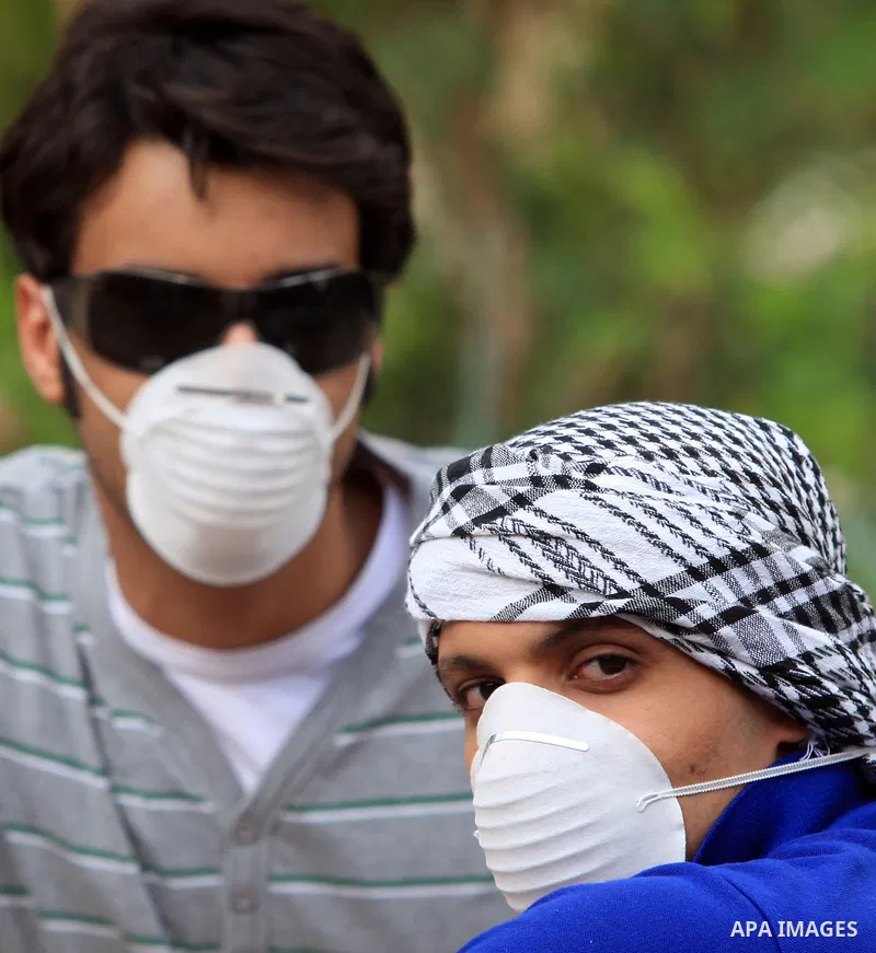 A Foreign tourists is seen putting a face mask as they visit the Pyramids in the Egyptian capital of Cairo on June 16, 2009. Egypt, hard hit by the more deadly H5N1 bird flu virus, detected its first H1N1 case early this...