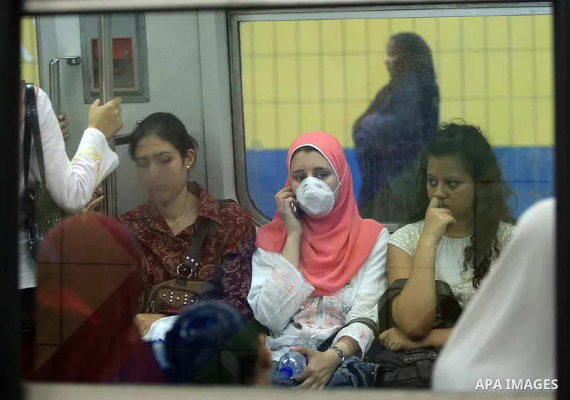 An Egyptians wear a face mask at the train station in Cairo, the capital of Egypt on June 14, 2009. Egypt, hard hit by the more deadly H5N1 bird flu virus, detected its first H1N1 case early this month in a 12-year-old A...