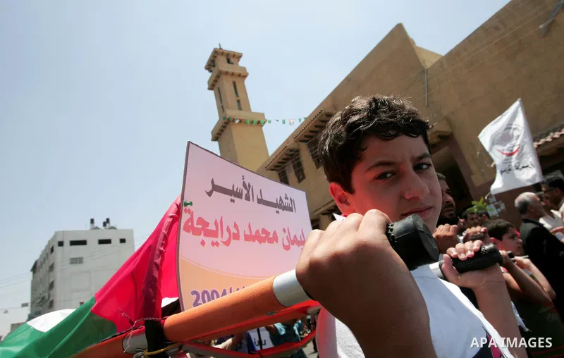 Palestinians display symbolic coffins in Gaza city June 25, 2009. referring to prisoners who died during their arrest at Israeli jails. Thursday marks the third anniversary of Israeli soldier Gilad Shalit's capture by Ha...