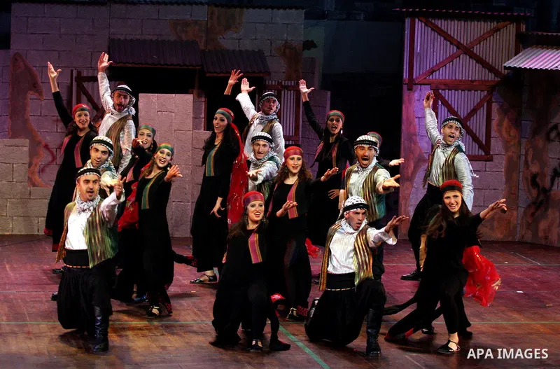 A Palestinian dancers perform a traditional dancing at the cultural palace in the West Bank city of Ramallah on June 27, 2009. Photo by Issam Rimawi