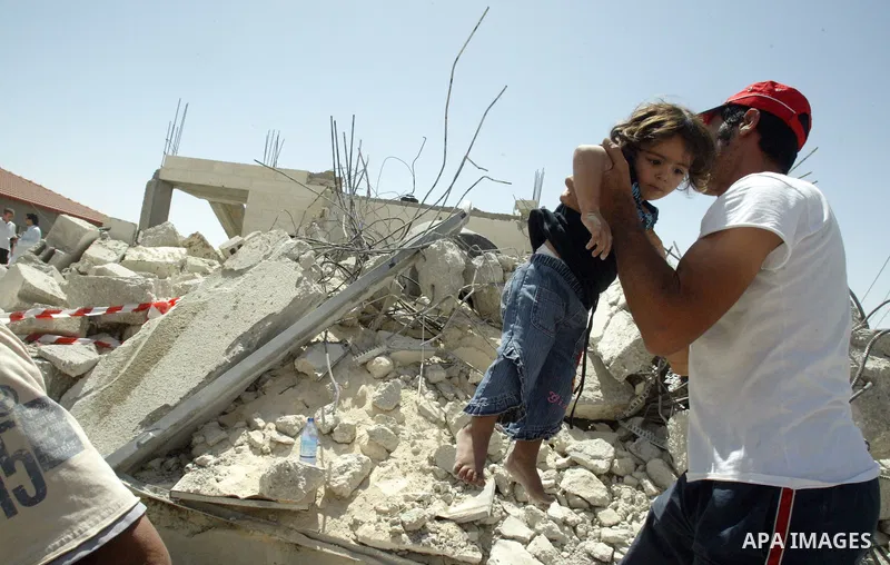 A Palestinians inspect the rubble of their house which demolished by Israeli bulldozer in East Jerusalem on June 30, 2009. photo by Mahfuz Abu Turk