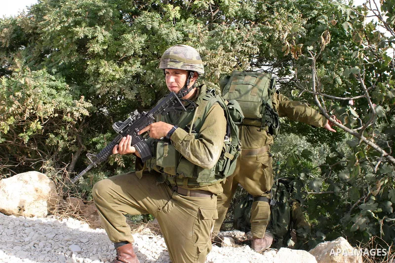 Israeli soldiers take position during a military operation in the West Bank city Hebron on July1, 2009. Photo by Najeh Hashlamoun