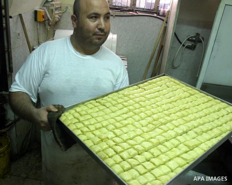 A Palestinian sweets maker prepares the dough of Baqlawa at his factory in the old city of Jerusalem on July4, 2009. Photo by Mahfuz Abu Turk