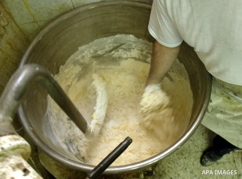 A Palestinian sweets maker prepares the dough of Baqlawa at his factory in the old city of Jerusalem on July4, 2009. Photo by Mahfuz Abu Turk