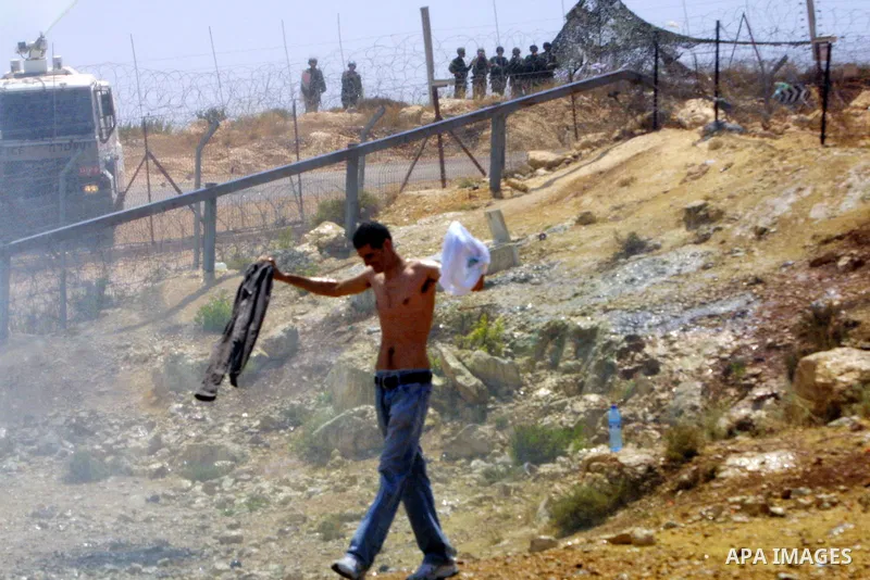 Israeli army sprays waste water on the Palestinian and foreign protestors during a protest against the construction of the West Bank separation barrier in the village of Nilin near Ramallah on July 10, 2009. Photo by Ned...