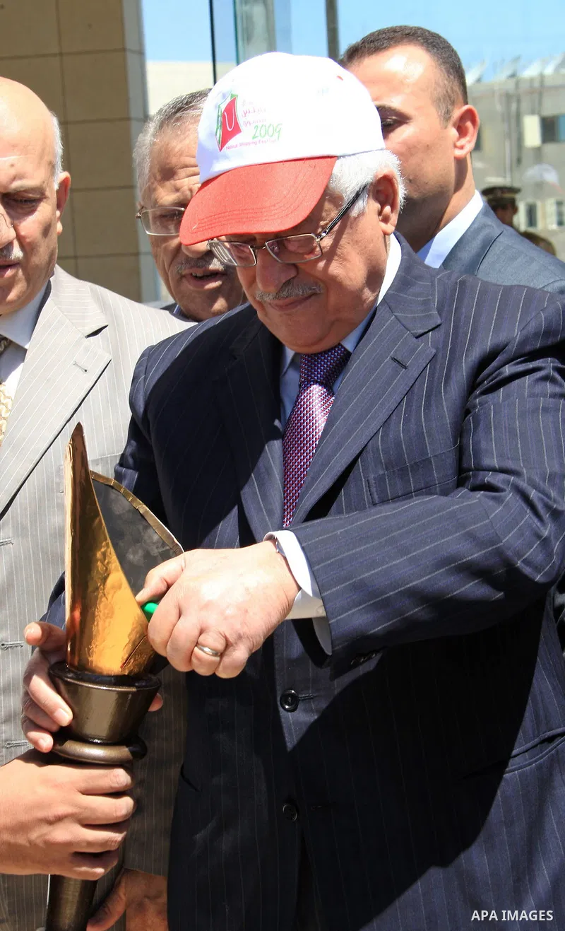 Palestinian President Mahmoud Abbas lights the torch of Nablus Shopping Festival in the West Bank City of Ramallah on July 12, 2009. Photo by Thaer Ganaim