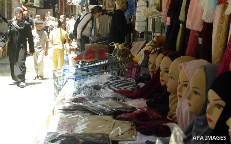 A Palestinians shop in a popular market in the old city of Jerusalem on July 12, 2009. Photo by Mahfouz Abu Turk