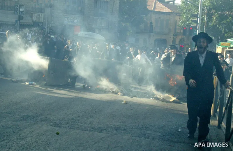 Ultra-Orthodox Jews scuffle with police during a protest against the arrest of a woman accused of child abuse in Jerusalem, Wednesday, July 16, 2009. Police suspect the woman suffers from a psychiatric disorder that driv...