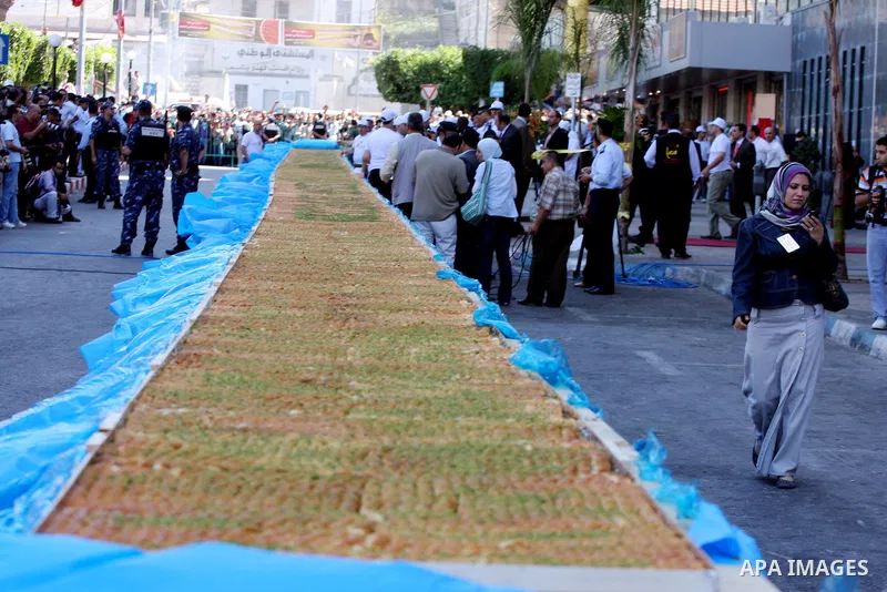 Palestinians making the biggest dish of traditional sweets Knafa into the Guinness Book of Records in the West Bank city of Nablus on July 18 2009. Photo by Issam Rimawi