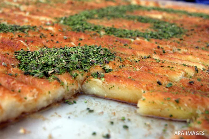 Palestinians making the biggest dish of traditional sweets Knafa into the Guinness Book of Records in the West Bank city of Nablus on July 18 2009. Photo by Issam Rimawi