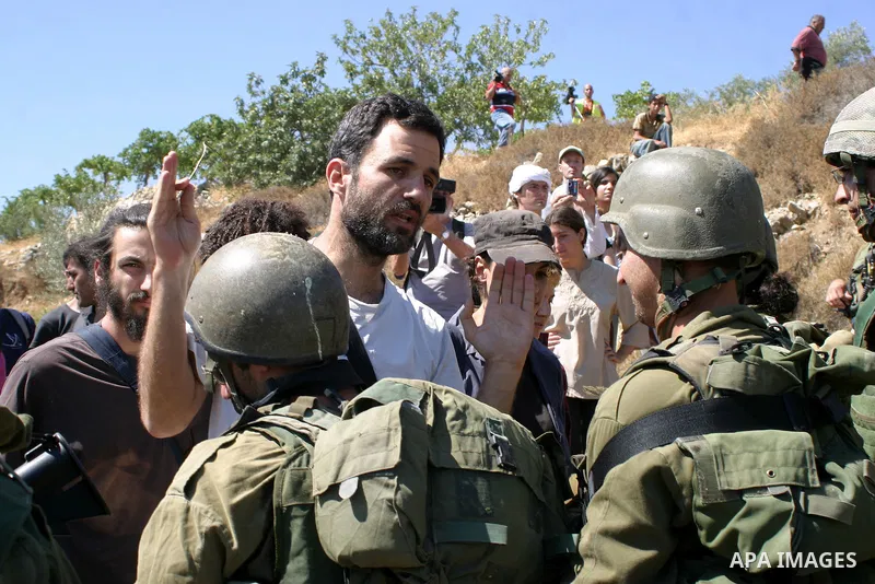 Palestinian, Israeli and international activists scuffles with Israeli soldiers in the West Bank village of Safa near Hebron on July 18, 2009. Photo by Najeh Hashlamoun