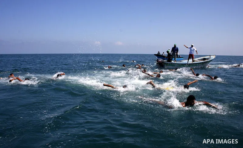 Palestinians participate in a swimming exercise organized by Hamas in the Mediterranean Sea off the coast of Deir al-Balah in the southern Gaza strip July 19, 2009 Photo by Ashraf amra