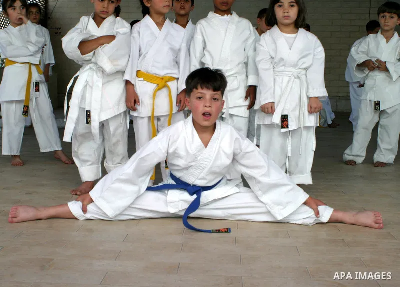 Palestinian children take part in a karate lesson during a summer camp in the West Bank city of Hebron, July 26, 2009. Photo by Najeh Hashlamoun