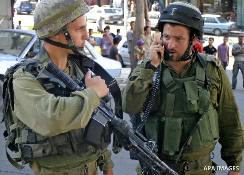 An Israeli soldiers patrol a streets in the West Bank city of Hebron on 30 July 2009. Photo by Najeh Hashlamoun
