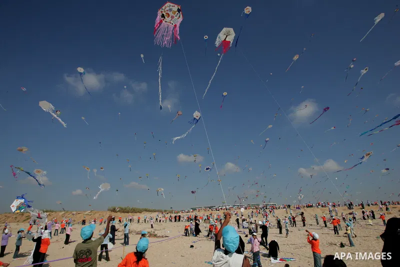 Palestinian children fly kites along the beach during a U.N. sponsored summer camp in Gaza City on July 30, 2009. Thousands of children in the Gaza Strip sought to break the world record for kite flying in a rare moment...