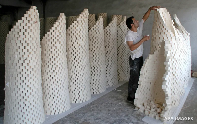 A Palestinian worker arranges the soap in columns at the soap factory in the West Bank city of Nablus in Aug 2, 2009. Nablus city is famous by its soap which made by olive oil. Photo by Nedal Shtieh