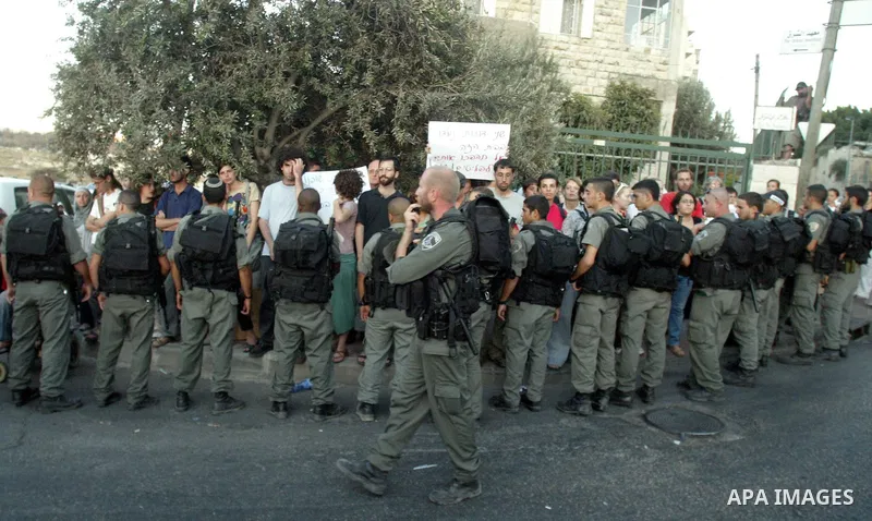 Left-wing Israeli activists protest against the eviction of Palestinians from their homes in Arab east Jerusalem on August 2, 2009. Club-wielding Israeli riot police evicted two Palestinian families from their homes in o...