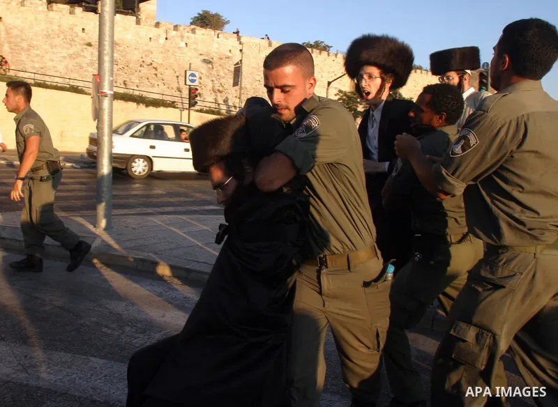 Israeli police officers detain an ultra-Orthodox Jew during a protest in Jerusalem August 8, 2009. Israeli police dragged away ultra-Orthodox men who blocked traffic outside the old walled city of Jerusalem on Saturday,...