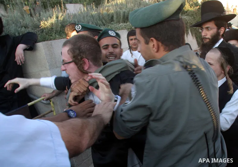 Israeli police officers detain an ultra-Orthodox Jew during a protest in Jerusalem August 8, 2009. Israeli police dragged away ultra-Orthodox men who blocked traffic outside the old walled city of Jerusalem on Saturday,...