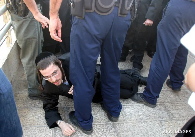 Israeli police officers detain an ultra-Orthodox Jew during a protest in Jerusalem August 8, 2009. Israeli police dragged away ultra-Orthodox men who blocked traffic outside the old walled city of Jerusalem on Saturday,...