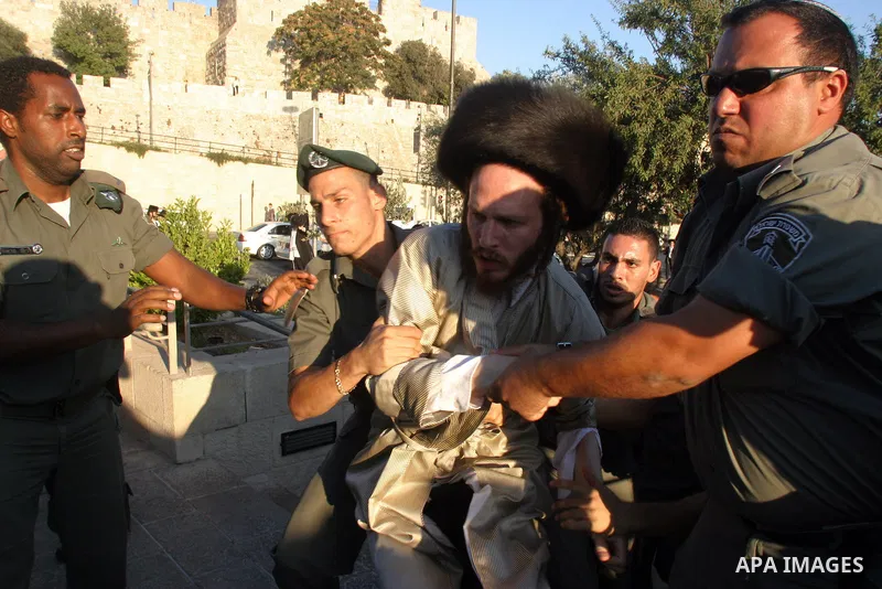 Israeli police officers detain an ultra-Orthodox Jew during a protest in Jerusalem August 8, 2009. Israeli police dragged away ultra-Orthodox men who blocked traffic outside the old walled city of Jerusalem on Saturday,...