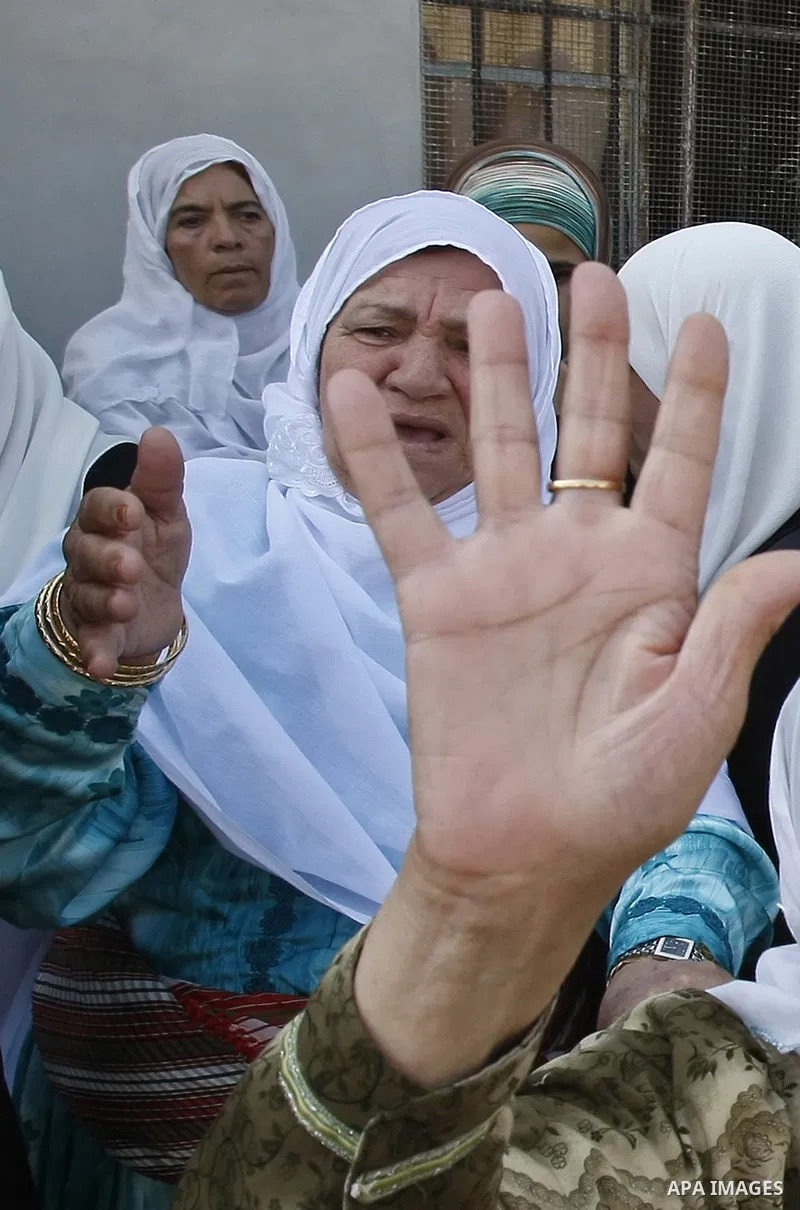 Palestinian relatives of Islamist Hamas movement member Fadi Hamadneh, 22, mourn following his death inside a Palestinian Authority (PA) prison on August 10, 2009 in a West Bank village near Nablus. Security officials sa...