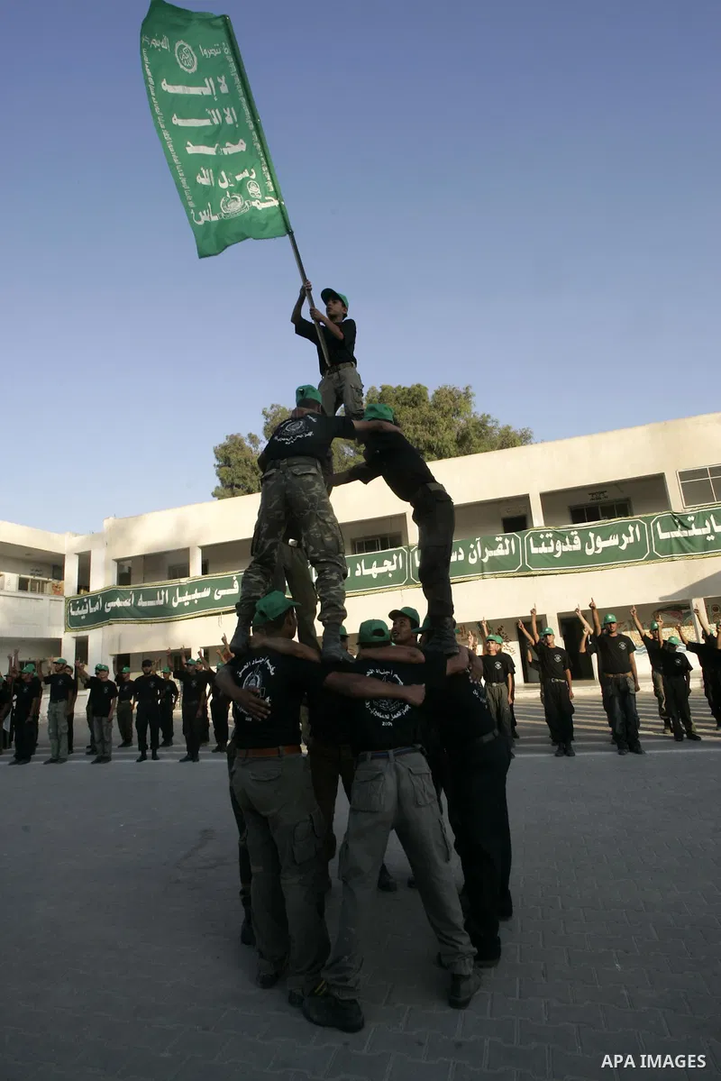 Palestinian boys from a Hamas summer camp exercises in formation with wooden guns in Rafah southern Gaza strip on August 11, 2009. Hamas holds summer camps throughout the Gaza Strip, where participants from 14 to 17 year...
